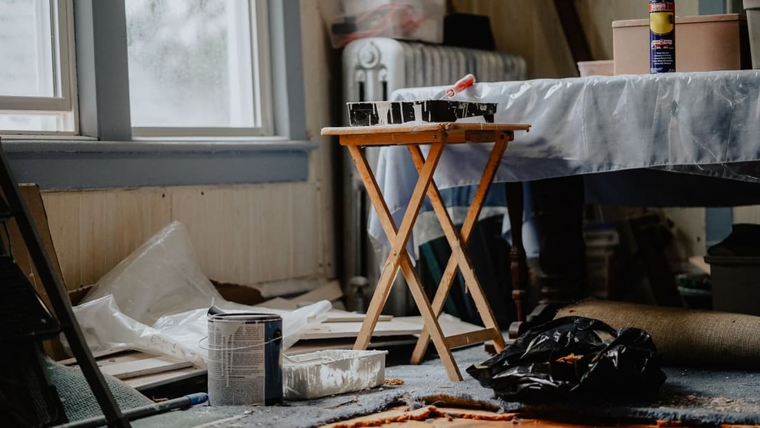 A home renovation in progress with paint and tools