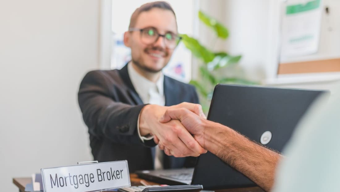 A handshake closing a real estate deal in an office